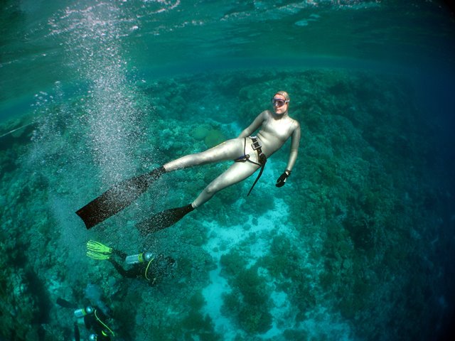 Emma Farrell freediving on Jackson Reef in the Red Sea, Egypt, with scuba divers in the background